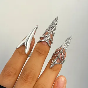 Close-up detail of three personalized gothic silver sharp nail rings worn on fingers