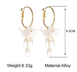 Detail view of 6.5cm white flower petal tassel earrings with faceted crystal drops.