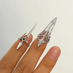 Close-up view of silver punk style claw rings with unique sharp gothic designs on fingers