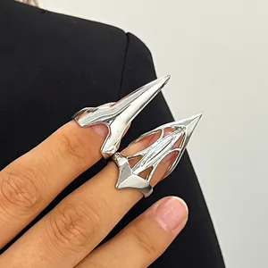 Detailed view of trendy silver-tone pointed claw nail rings in hollow and solid designs
