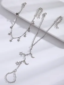 Detailed view of silver star and moon charms hand harness and bracelet jewelry set
