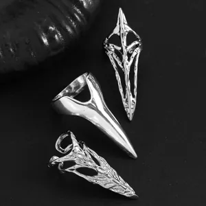 Close-up of gothic silver nail rings with intricate filigree and claw designs