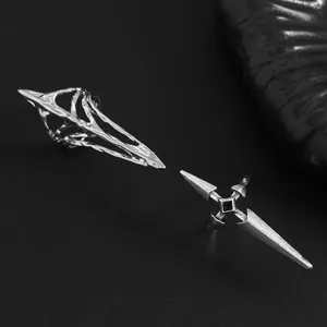 Macro view showing the intricate texture of gothic silver nail rings with cross and cage designs
