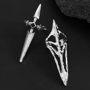 Macro detail of gothic silver claw rings featuring cross and abstract mesh designs