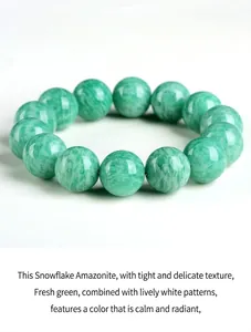 Detail view of natural green Amazonite beaded bracelet featuring white snowflake patterns