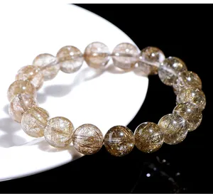 Close-up macro view of natural silver rutilated quartz beads with needle-like inclusions