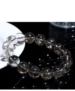 Detailed view of natural silver rutilated quartz beads showing fine internal needle inclusions.