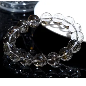 Close-up of natural silver rutilated quartz beads showing intricate needle inclusions.