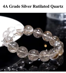 Detail of natural silver rutilated quartz bead bracelet with clear crystal texture