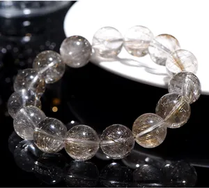 Macro shot of 7A natural silver rutilated quartz bracelet with clear inclusions.