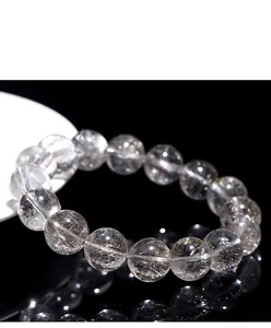 Macro view of 3A grade silver rutilated quartz beads showing natural hair-like inclusions