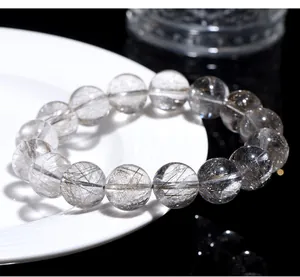 Close-up detail showing the needle inclusions in natural silver rutilated quartz beads