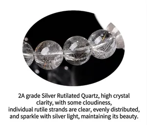 Macro detail of natural 2A grade silver rutilated quartz beads with clear rutile needles