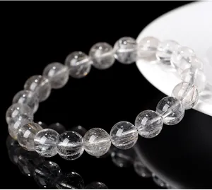 Close-up detail of natural silver rutilated quartz beads showing clear crystal texture.
