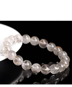 Exquisite macro detail of natural silver rutilated quartz beads on a bracelet