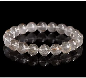 Close-up detail of natural silver rutilated quartz bead bracelet with clear inclusions
