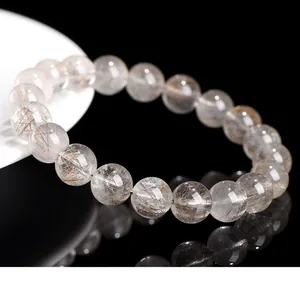 Close-up of natural silver rutilated quartz bead bracelet with delicate inclusions