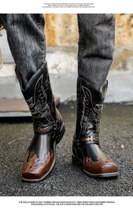 Detail of embroidered western cowboy boots with rubber sole and pointed toe design.