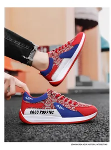 Detailed macro shot of red and blue designer canvas sneakers with stylish text patterns.