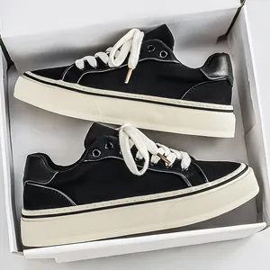 Stylish men's black canvas sneakers with thick white soles in a classic white box