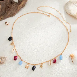Macro view of Bohemian beach style body chain with golden starfish and sea shell charms