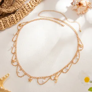 Gold layered body chain with starfish and shell charms on beach themed background