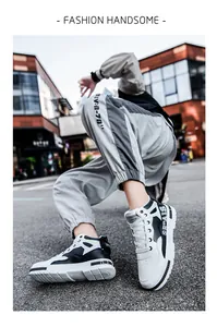 Close-up of men's black and white mid-top sneakers with urban street style
