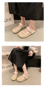 Detailed view of beige woven mesh mules with adjustable metal buckle strap.