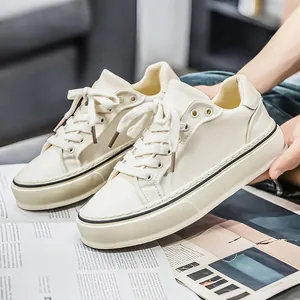 Stylish men's minimalist beige canvas sneakers featuring thick soles and classic white laces
