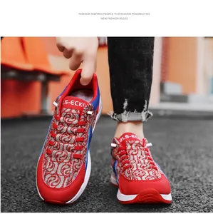 Close-up view of stylish red and grey patterned men's canvas sneakers with blue accents