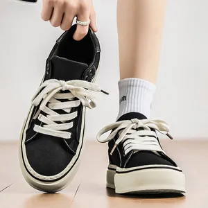 Classic black canvas sneakers with thick white soles and stylish wide laces for men