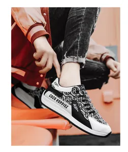 Close-up of stylish black and white canvas sneaker with unique pattern and side text
