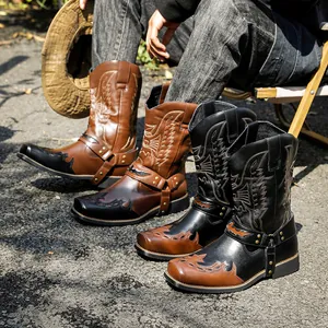 Western cowboy boots with vintage embroidery and harness detail in brown and black