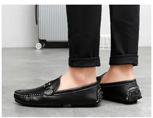 Side view of men's black leather loafers with white contrast stitching and metal buckle.