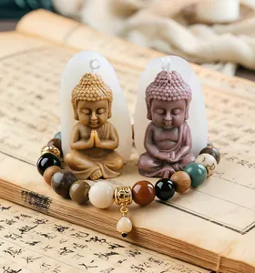 Close-up view of finished little Buddha candles alongside their white silicone molds
