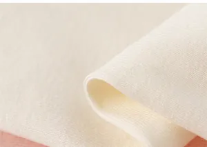 Close-up of soft white cotton fabric detail showing breathable knitted texture and elasticity