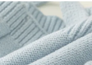 Detailed close-up of soft light blue knit fabric showing premium texture and weave.