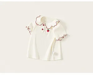 Close-up of girl's sweet doll collar t-shirt with strawberry embroidery and ruffles.