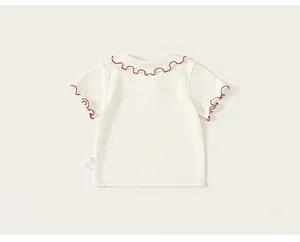 Sweet girl's cream short sleeve t-shirt featuring red lettuce edge trim back detail