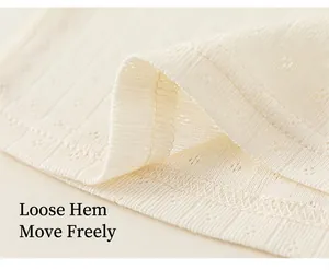 Macro detail of off-white ribbed pointelle fabric hem on a comfortable girls summer T-shirt