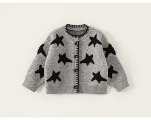 Detail van grijs vest voor kinderen met zwarte sterpatronen en comfortabele ribmanchetten