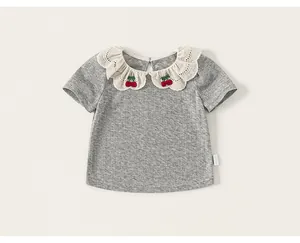 Detail showing delicate lace collar with embroidered cherries on a gray ribbed girl's tee.