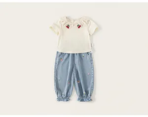 Toddler girls summer clothing set featuring a ruffled cherry collar top and embroidered denim pants