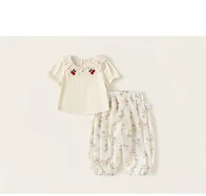 Two-piece girl's summer set with cherry embroidered ruffled top and floral print pants