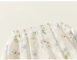Close-up detail of children's floral skirt with elastic waistband and soft fabric