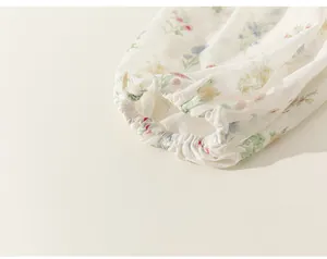 Detail view of the elastic ruffled cuff on a floral print girl's summer T-shirt.