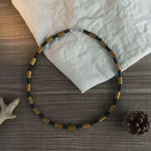 Detailed view of bohemian wood and coconut shell bead necklace for men's beach surf style