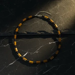 Detailed view of bohemian men's surfing necklace with wood and coconut shell beads