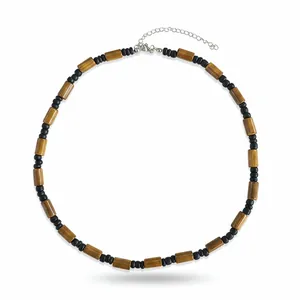 Detail of Bohemian style necklace with brown wood and black coconut shell beads