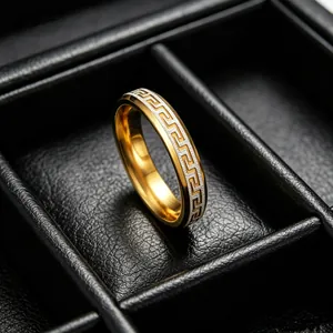 Macro view of two-tone titanium steel ring with classic Greek key pattern on black leather